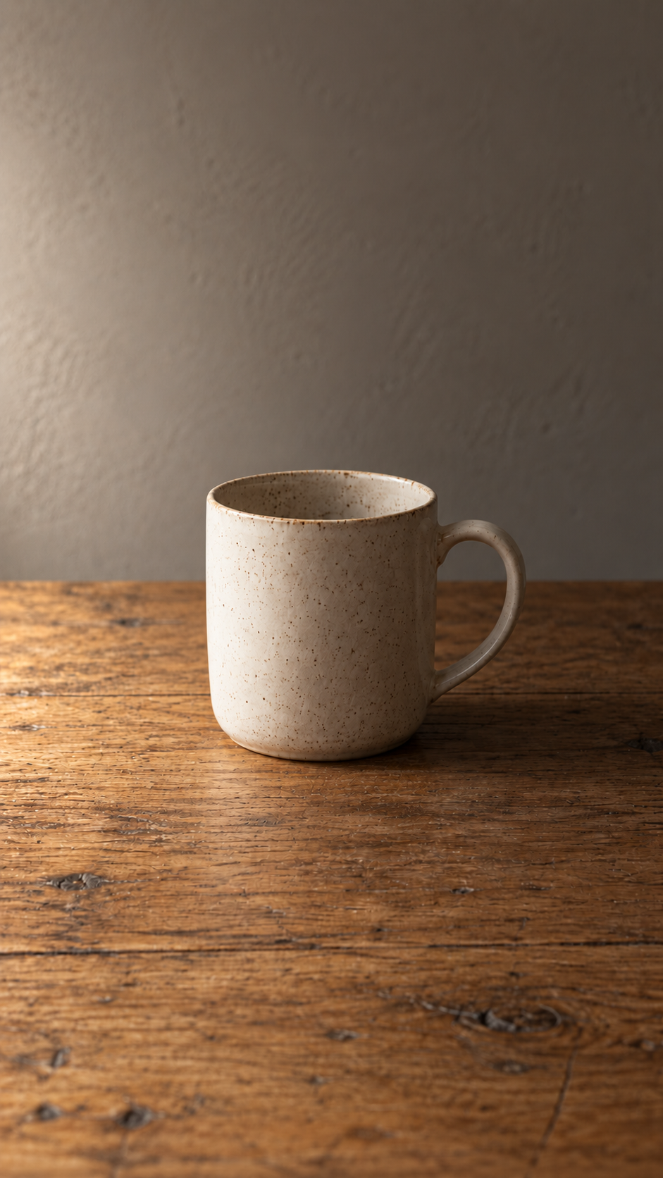 Side light: illustrative ivory mug on an oak table